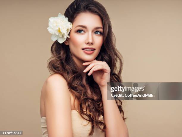 beautiful portrait of young girl with flower in her hair - summer hair care stock pictures, royalty-free photos & images