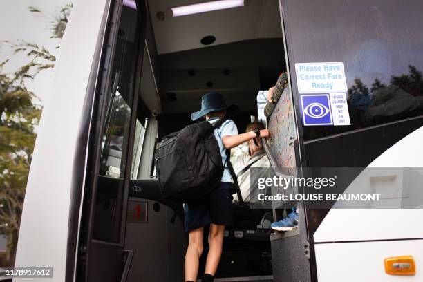 australian schoolboy boards the bus - carbon footprint reduction stock pictures, royalty-free photos & images