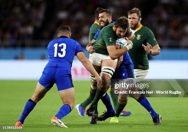 Lodewyk De Jager of South Africa is challenged by Luca Morisi of Italy and Jayden Hayward of Italy during the Rugby World Cup 2019 Group B game...