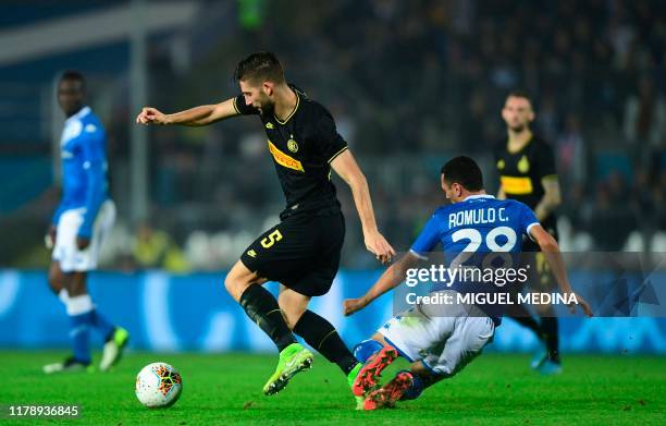 Inter Milan's Italian midfielder Roberto Gagliardini fights for the ball with Brescia's Italian Brazilian defender Romulo during the Italian Serie A...