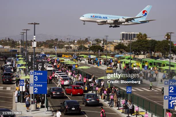 An Airbus SE A380-800 aircraft operated by Korean Air Lines Co. Lands as vehicles from Uber Technologies Inc., Lyft Inc., and taxi cabs enter the...