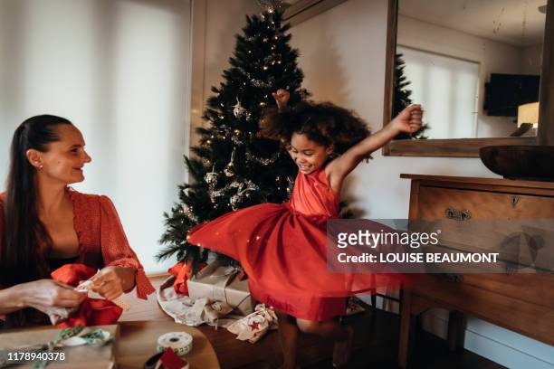 little girl dancing in red christmas eve dress - family holidays australia stock pictures, royalty-free photos & images