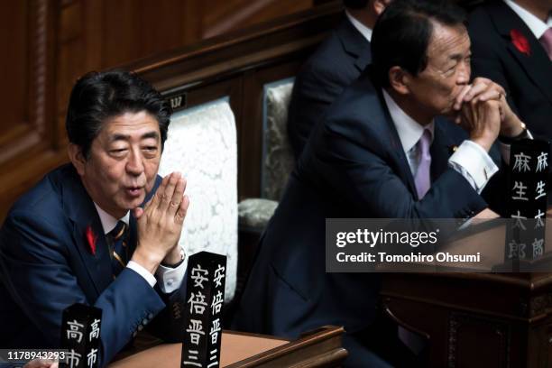 Japan's Prime Minister Shinzo Abe and Deputy Prime Minister and Finance Minister Taro Aso attend a plenary session at the lower house of the...