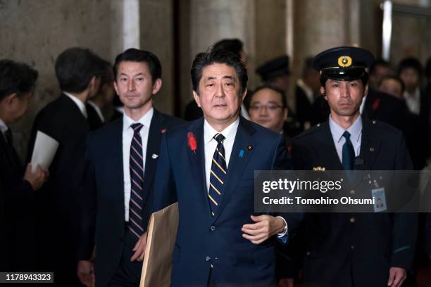 Japan's Prime Minister Shinzo Abe arrives at the chamber to deliver his policy speech at the lower house of the parliament on October 4, 2019 in...