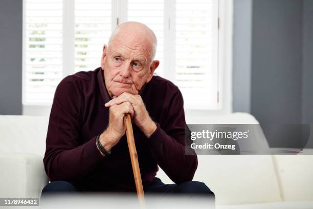 thoughtful senior man at home - retirement community staff stock pictures, royalty-free photos & images
