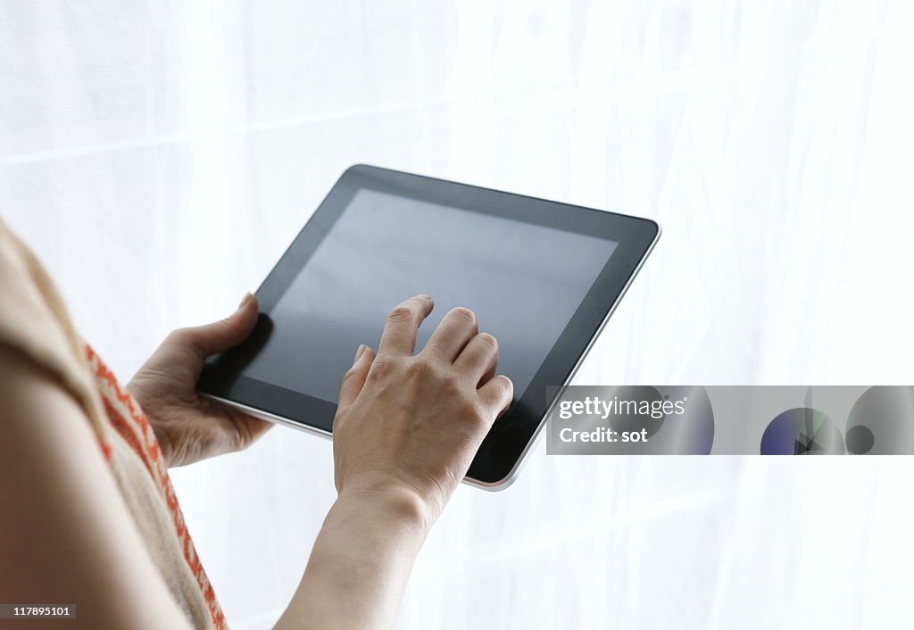 Female using digital tablet