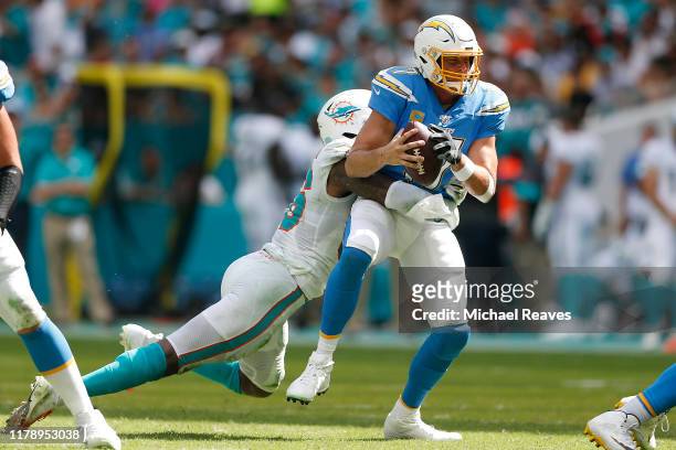 Taco Charlton of the Miami Dolphins sacks Philip Rivers of the Los Angeles Chargers during the third quarter at Hard Rock Stadium on September 29,...