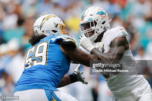 Taco Charlton of the Miami Dolphins battles with Sam Tevi of the Los Angeles Chargers during the second quarter at Hard Rock Stadium on September 29,...