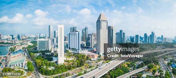aerial panorama over highrise highways skyscraper cityscape marina bay singapore - singapore city stock pictures, royalty-free photos & images