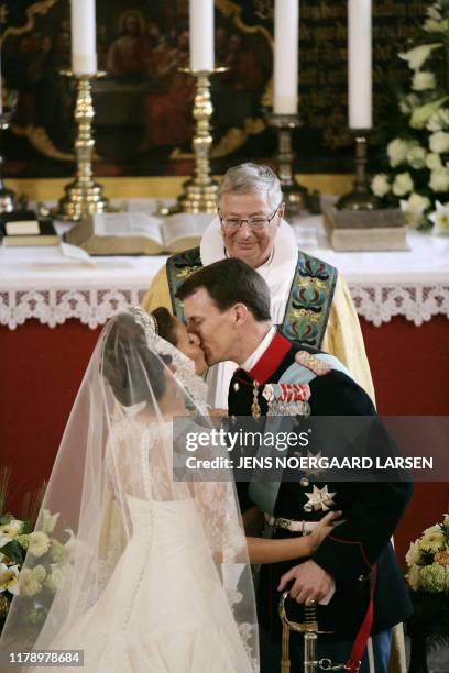 Bishop Erik Norman Svendsen watches Prince Joachim of Denmark, Queen Margrethe's youngest son, kissing his bride, French Miss Marie Cavallier, at...