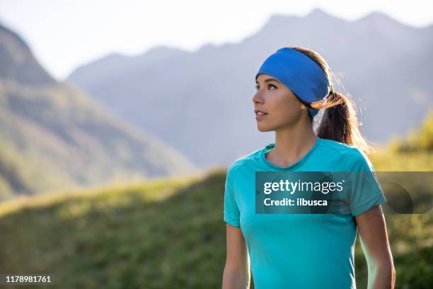 beautiful young woman hiking on italian alps mountains - hair band stock pictures, royalty-free photos & images