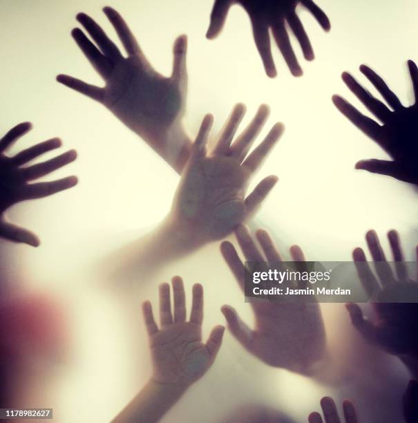 group of hands shadow - hands behind glass stock pictures, royalty-free photos & images