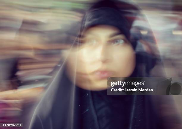 blurred motion portrait of iranian woman - iranian woman stock-fotos und bilder