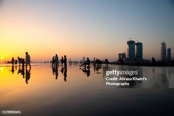 sunset silhouette - karachi beach bildbanksfoton och bilder