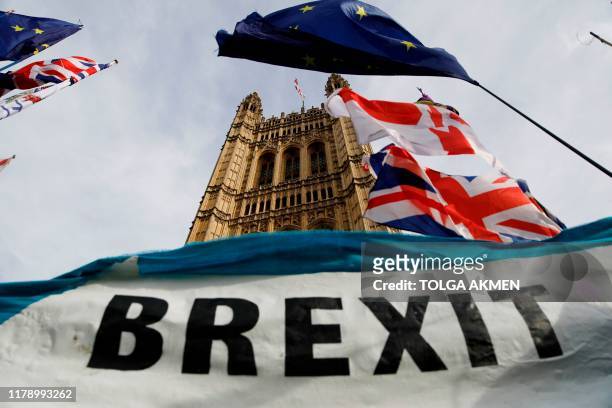 Pro-Brexit banner is seen outside the Houses of Parliament in London on October 30. 2019. - Britain's political leaders tested their election pitches...