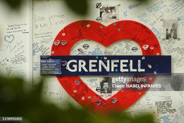 Messages of support are written on a wall surrounding Grenfell tower in west London on October 30, 2019. The emergency response to a 2017 high-rise...