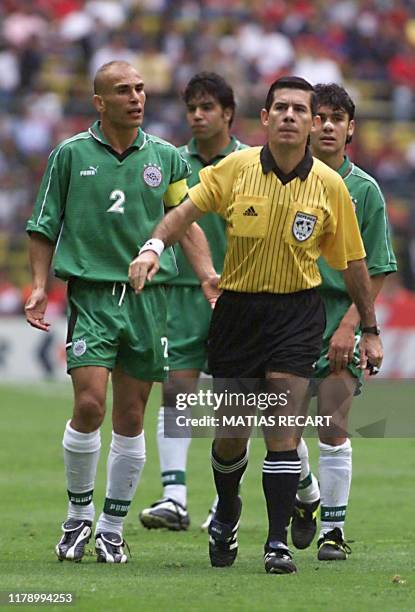 Egyptian soccer players protrest a call by official Ubaldo Aquino of Paraguay during their FIFA Confederation Cup match against Saudi Arabia 29 July...