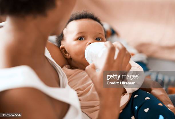 making sure she grows into a heathy and strong princess - baby being fed stock pictures, royalty-free photos & images