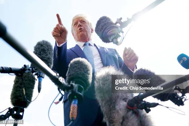 President Donald Trump talks to journalists on the South Lawn of the White House before boarding Marine One and traveling to Walter Reed National...