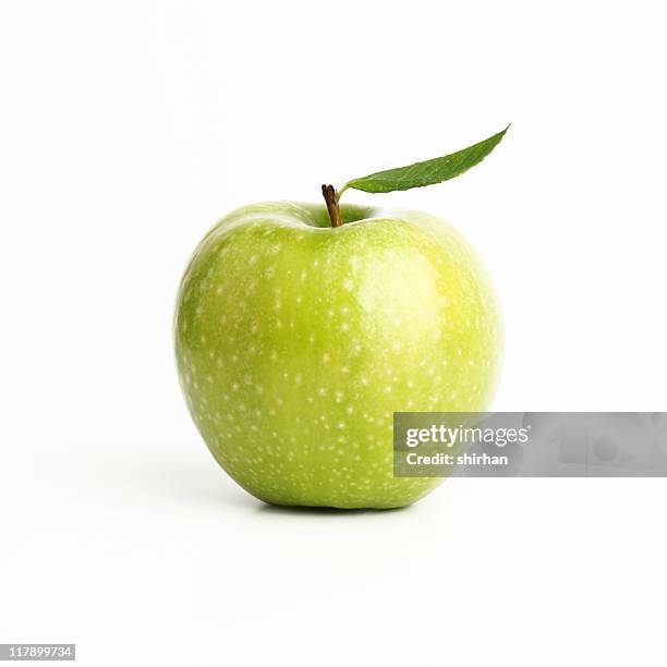 single perfect green apple on a white background - green apples stock pictures, royalty-free photos & images