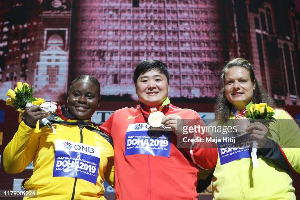Silver medalist Danniel Thomas-Dodd of Jamaica, gold medalist Lijiao Gong of China and bronze medalist Christina Schwanitz of Germany stand on the...