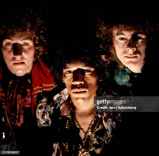 Portrait of the members of English-American Rock group the Jimi Hendrix Experience as they pose, lit from below, New York, New York, July 26, 1967....