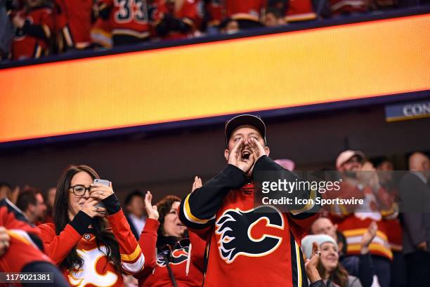 Calgary Flames fans cheer during the shootout in an NHL game where the Calgary Flames hosted the Florida Panthers on October 24 at the Scotiabank...