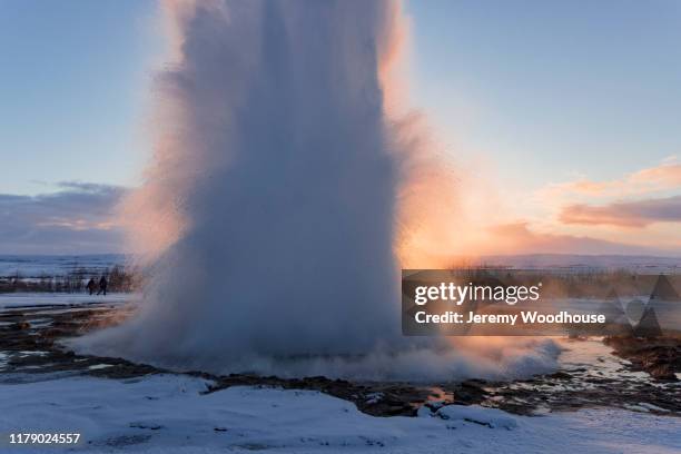 strokkur geyser erupting at sunrise - strokkur stock pictures, royalty-free photos & images