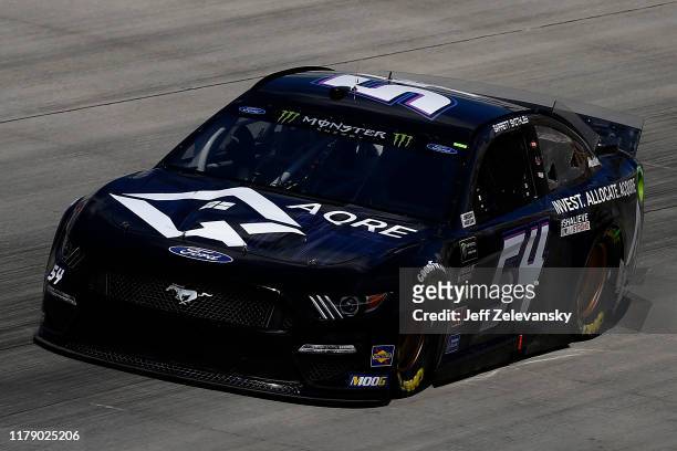Garrett Smithley, driver of the AQRE.app Ford, drives during practice for the Monster Energy NASCAR Cup Series Drydene 400 at Dover International...