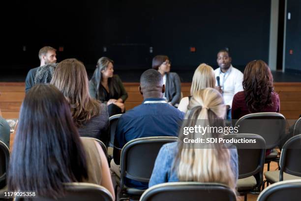 rear view photo of audience listening to panel presentation - câmara municipal edifício do governo local imagens e fotografias de stock