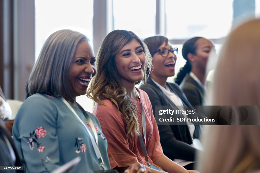 Diverse women enjoy laugh during expo session