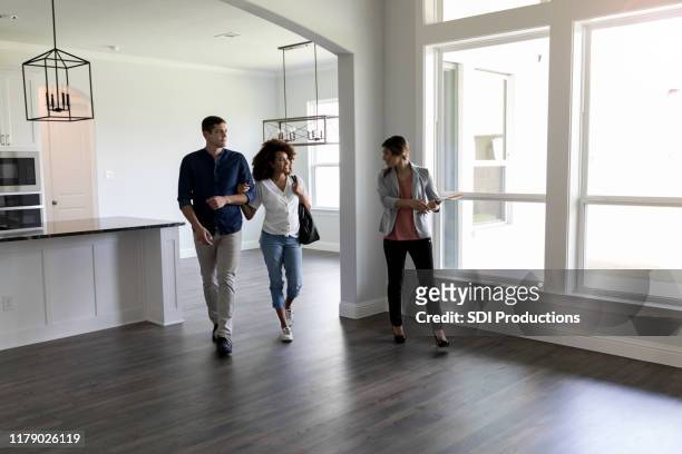 couple meets with real estate agent - real estate agent stock pictures, royalty-free photos & images