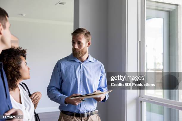 home inspector discusses issues with homeowners - quality control inspector stock pictures, royalty-free photos & images