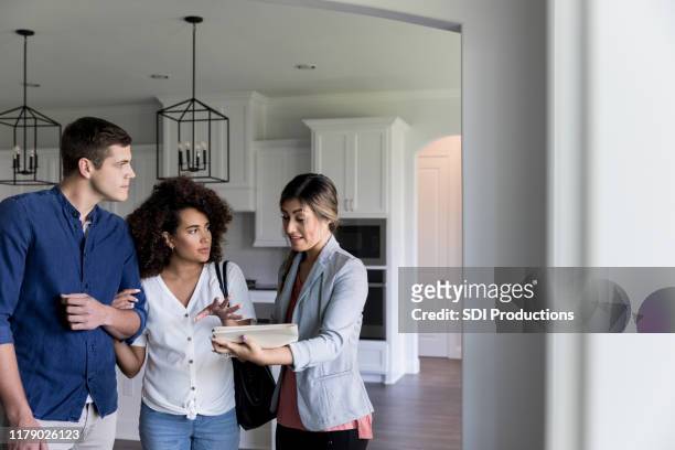 potential homeowners looking at new home - house viewing stock pictures, royalty-free photos & images