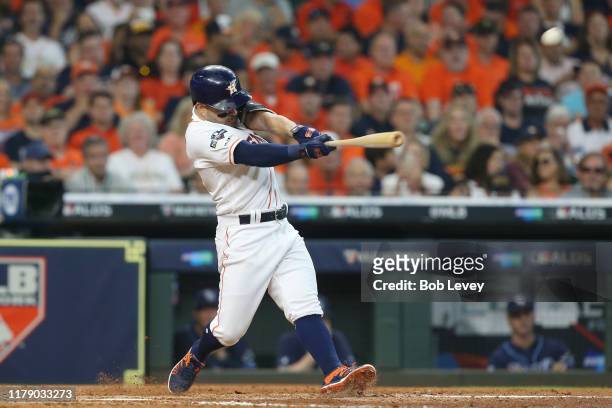 Jose Altuve of the Houston Astros hits a two-run home run off of Tyler Glasnow of the Tampa Bay Rays during the fifth inning in game one of the...