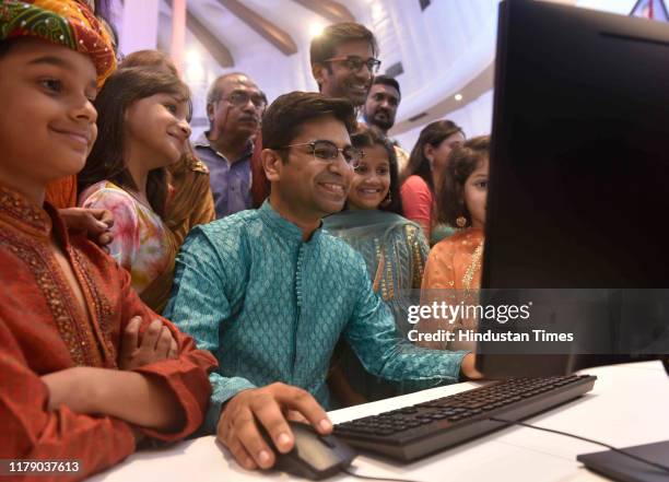 Stock broker with his family watch the Diwali Muhurat trading at Bombay Stock Exchange , on October 27, 2019 in Mumbai, India.