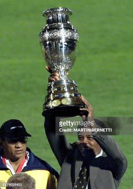 The technical director of the Colombian team, Francisco Maturno, lifts up the Copa America trophy on July 29, 2001 in the Nemesio Camacho Stadium in...
