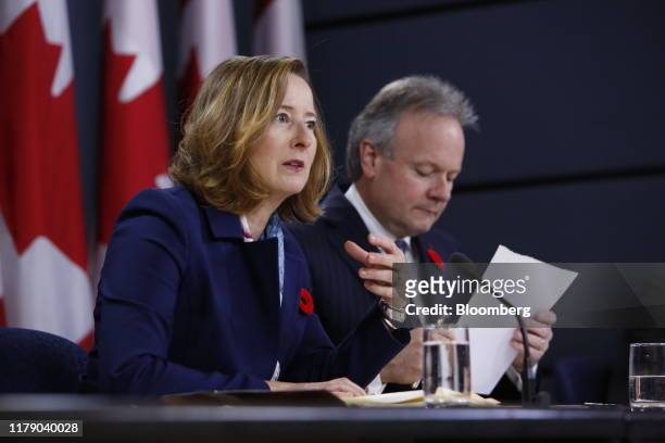 Carolyn Wilkins, senior deputy governor at the Bank of Canada, left, speaks while Stephen Poloz, governor of the Bank of Canada, listens during a...