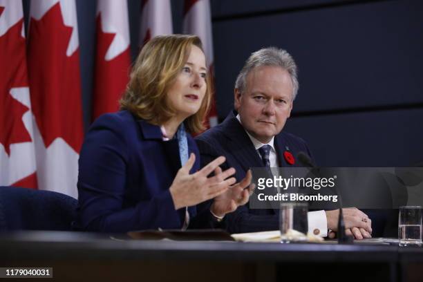 Stephen Poloz, governor of the Bank of Canada, right, listens while Carolyn Wilkins, senior deputy governor at the Bank of Canada, speaks during a...