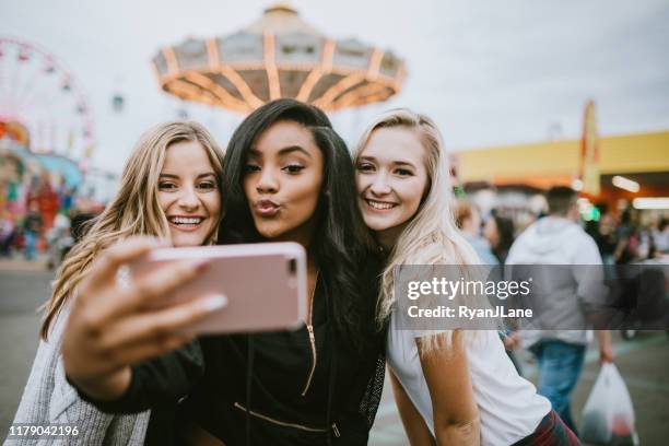 teenage women friend group enjoying state fair - puckering stock pictures, royalty-free photos & images