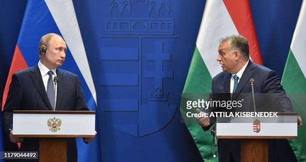 Hungarian Prime Minister Viktor Orban and Russian President Vladimir Putin address a press conference at the residence of the prime minister office...