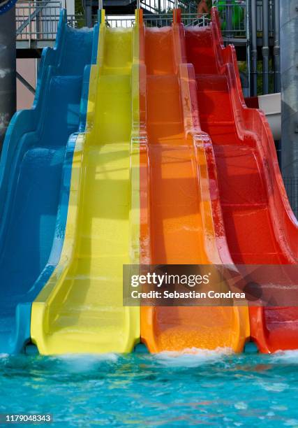 colorful water slides, closeup of photo, romania. - tobogán de agua fotografías e imágenes de stock
