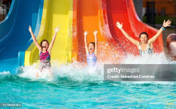 family on water slide at aquapark, romania. - parco divertimenti foto e immagini stock