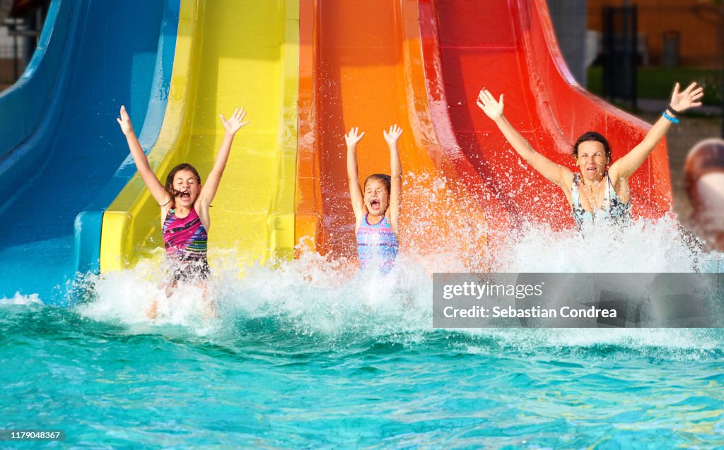 Family on water slide at aquapark, Romania.