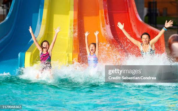 family on water slide at aquapark, romania. - holiday 2019 stock pictures, royalty-free photos & images