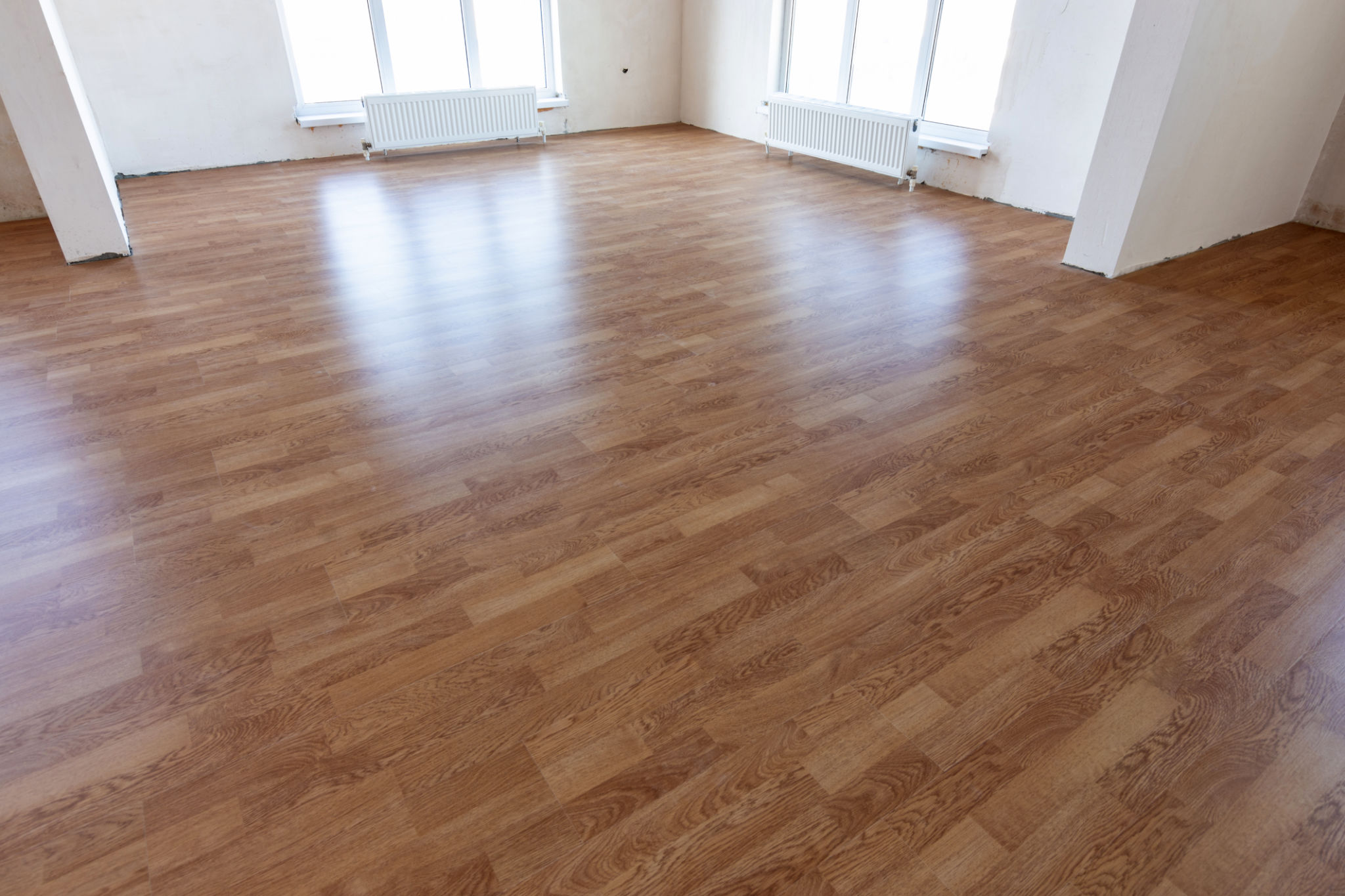 Laminate flooring in the interior of a spacious room in a new building Laminate flooring in the interior of a spacious room in a new building