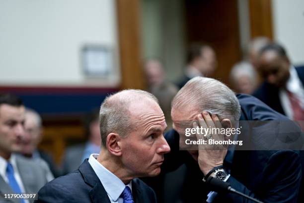 Dennis Muilenburg, chief executive officer of Boeing Co., left, talks during a break of the House Transportation and Infrastructure Committee hearing...