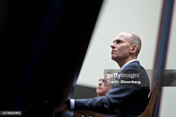 Dennis Muilenburg, chief executive officer of Boeing Co., right, listens during a House Transportation and Infrastructure Committee hearing in...