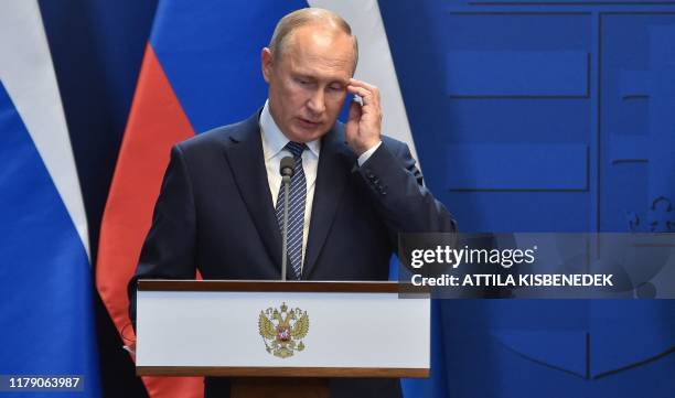 Russian President Vladimir Putin addresses a press conference with the Hungarian Prime Minister Viktor Orban at the residence of the prime minister...