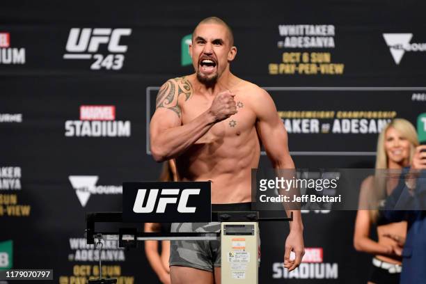 Robert Whittaker of New Zealand poses on the scale during the UFC 243 weigh-in at Marvel Stadium on October 05, 2019 in Melbourne, Australia.